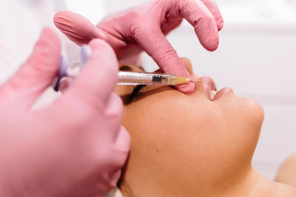 woman getting Botox injection in lips